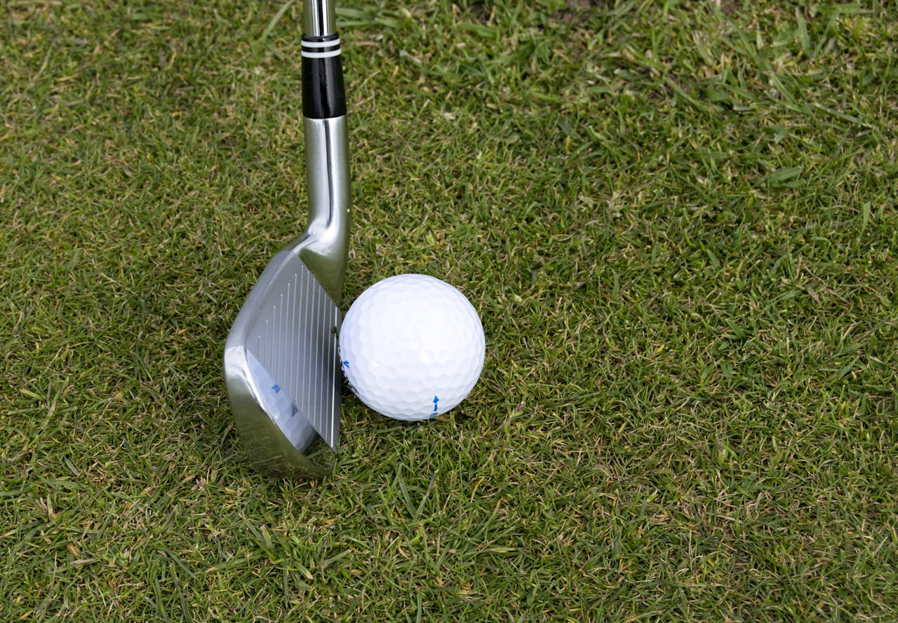 Crafting Captivating Headlines: Your awesome post title goes here Golf club and ball on grass showcasing a leisure sport scene outdoors.